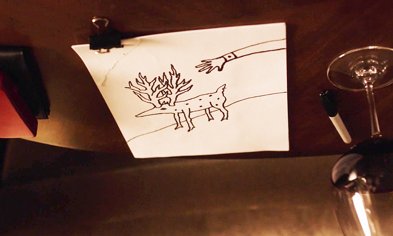 Gordons drawing of a creature with spots, antlers, on a hill, with an arm stretching towards it