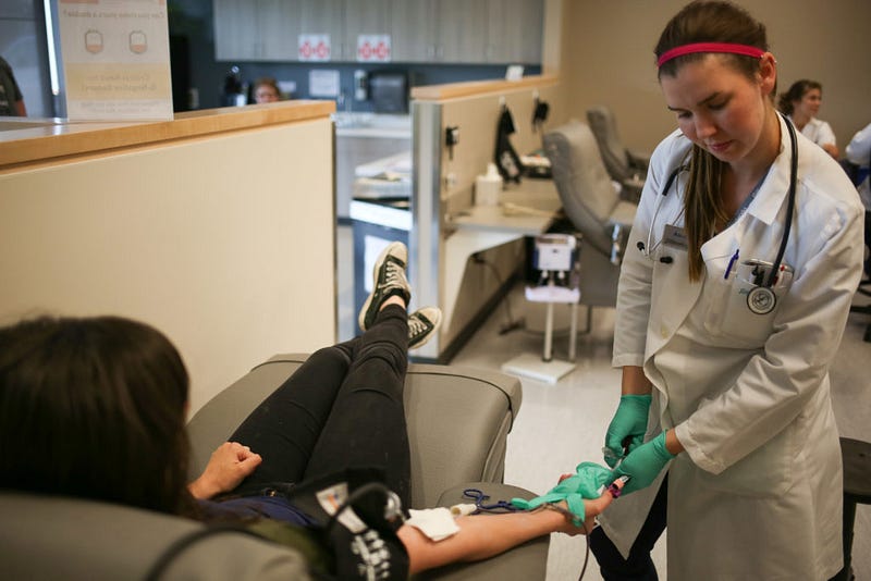 Crape checks the monitor on the machine showing Worden's information while she gives blood on June 3, 2016. Worden gave a pint of blood in around five minutes. The plasma will be extracted from it later. 