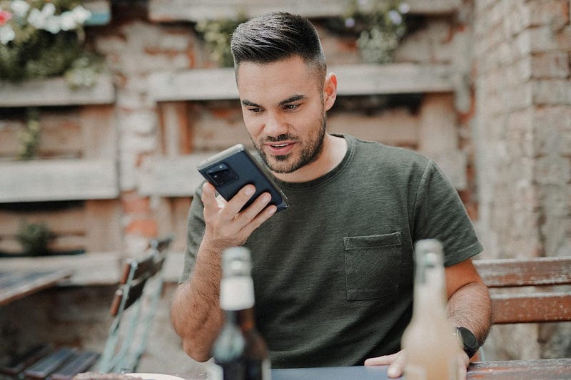 A person using voice search on a cellphone