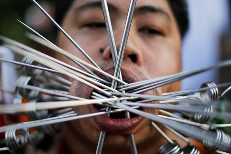 A devotee of the Chinese Samkong Shrine walks with piercings on his mouth during a procession celebrating the annual vegetarian festival in Phuket, Thailand October 4, 2016. REUTERS/Jorge Silva