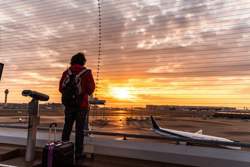 A man watches the sunset a Tokyo’s Haneda International Airport