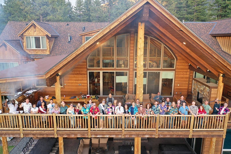 The Iris team all wearing Hawaiian shirts on a large balcony