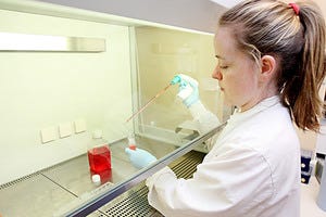 A woman works in a lab. 