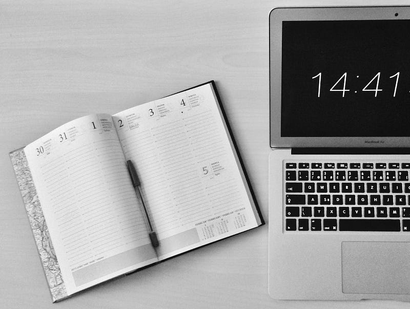 planner and macbook with clock in clock out app