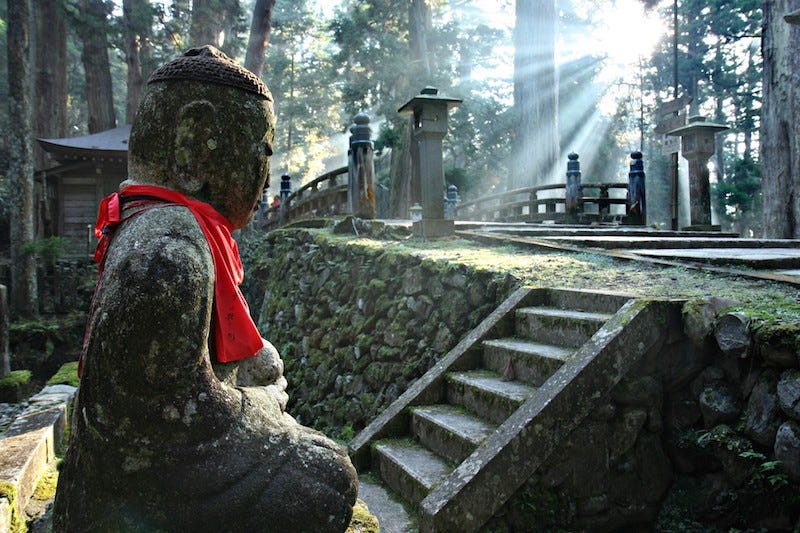 A Buddhist statue of Jizo sits meditating in Mt. Koya’s Oku-no-in inner sanctum