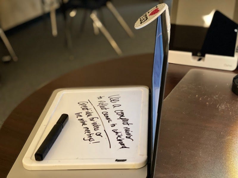 Side view of using a mirror on a chromebook to reflect the front facing camera.