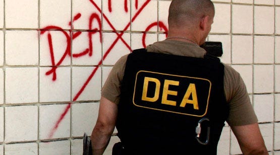 A Drug Enforcement Adminsitration agent marks a church after he searches it for survivors and victims of Hurricane Katrina in New Orleans, Louisiana September 11, 2005. U.S. President George W. Bush headed to the U.S. Gulf Coast on Sunday to confront a region where the flood waters of Hurricane Katrina were receding but residents' frustration still overflowed and political recriminations were rising. REUTERS/Brian Snyder BS/VP - RTRNJSV