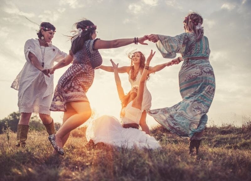 Image of hippie women dancing at sunset