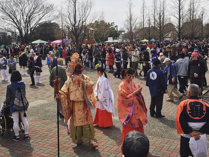 Throngs of revelers from the Kanamara Festival gather at Daishi Park