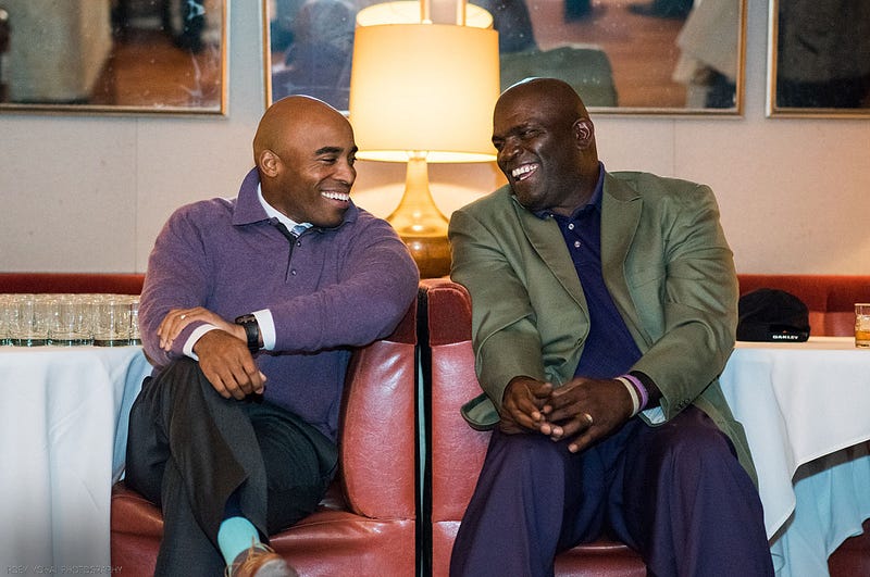 Barber, (left) seen alongside superstar linebacker Lawrence Taylor. (right) Photo via Thuzio 