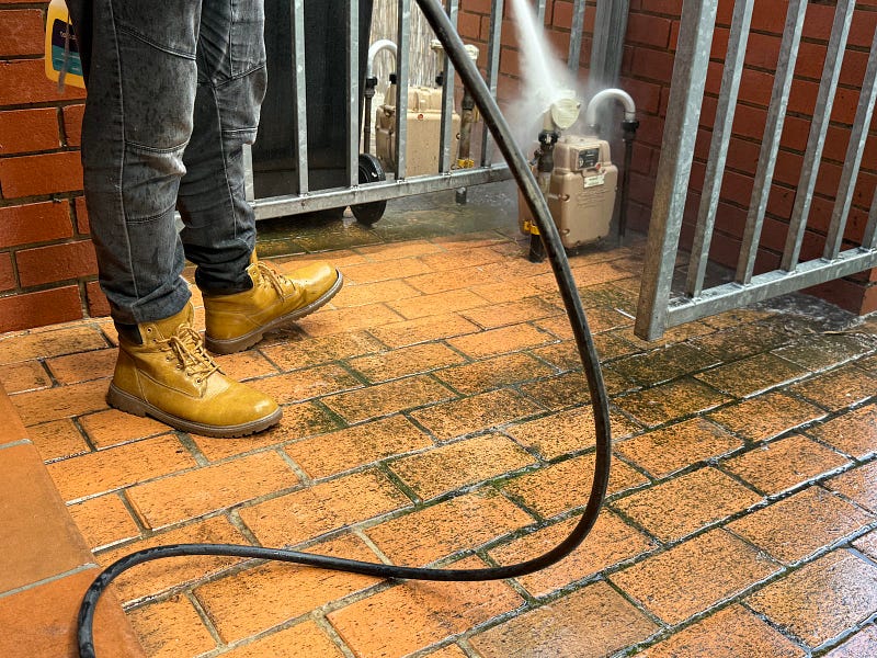 High-pressure cleaning exterior of corporate office building 