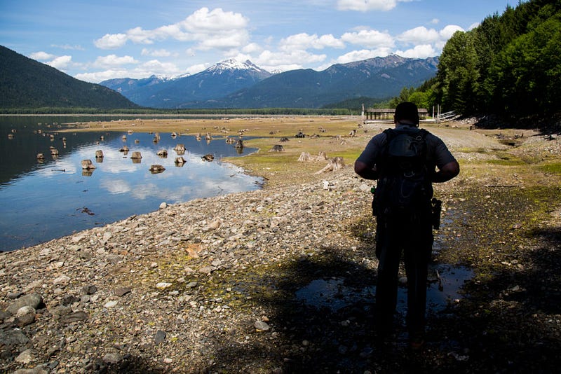 Park service ranger Kevin Davis walks on May 14, 2016 near the shore of Ross Lake's northern end. The Hozomeen campground, a hotbed both for Canadian recreationists and drug smugglers of different varieties, lies a few hundred yards ahead of him.