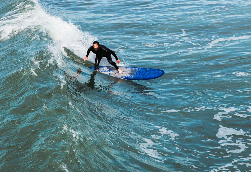 Image of a surfer catching a wave