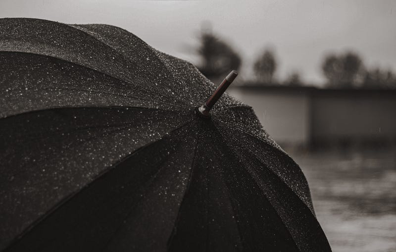 Black umbrella beaded with water