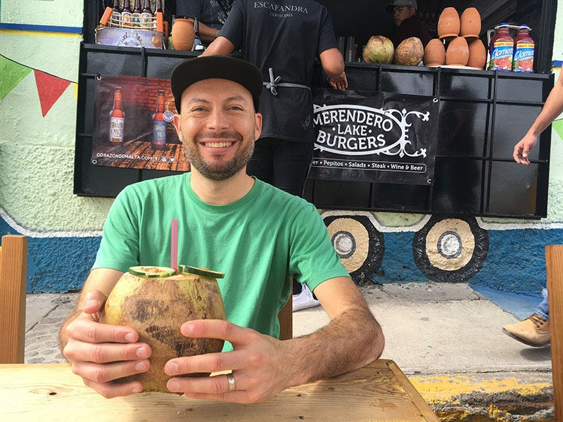 Greg drinking out of a coconut