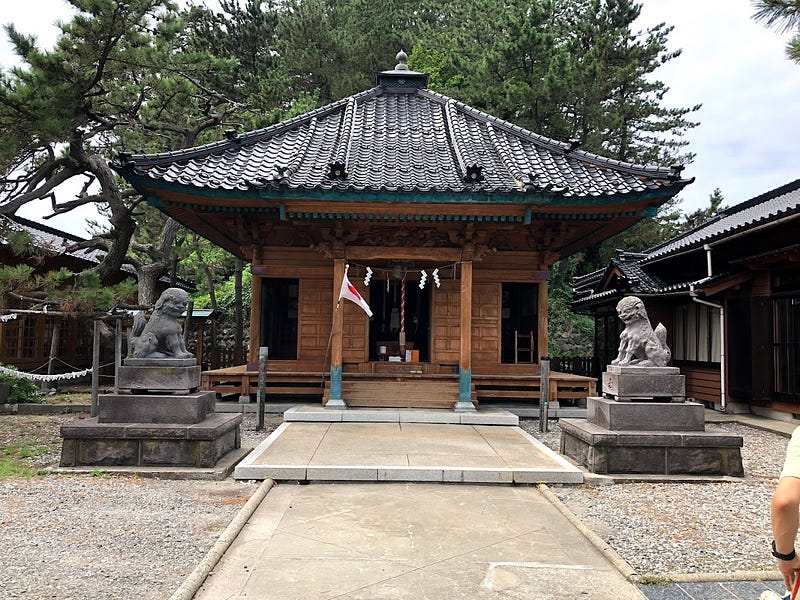 A Japanese shrine with Komainu dog statues guarding the entrance in Nezugaseki near Mt. Nihonkoku, one of the 100 Famous Mountains of Yamagata in Tohoku, north Japan