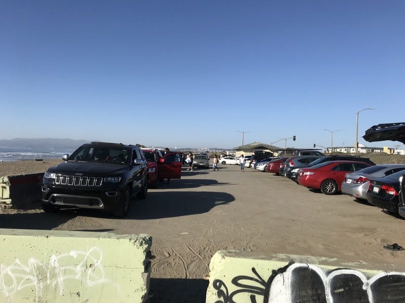A parking lot under a blue sky.