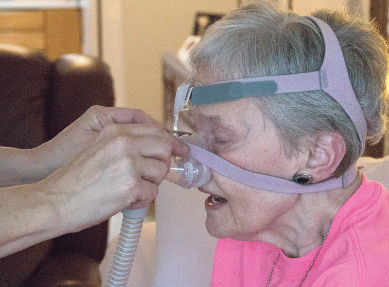 ALS patient Nelda Lautenbach, 68, uses her BiPAP machine to push air down her lungs. Lautenbach uses the BiPAP machine to help her breathe when she lies down to relieve pressure on her chest.