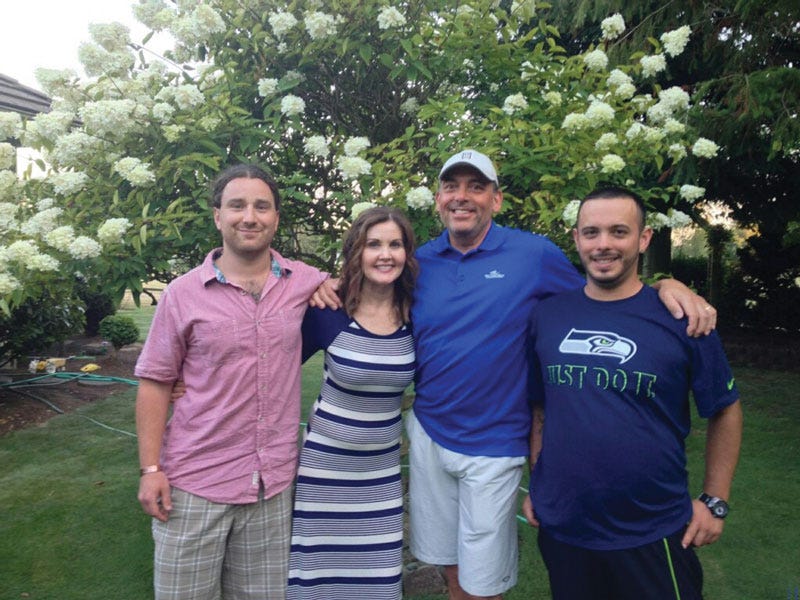 Drew Fisher with his adoptive parents and brother