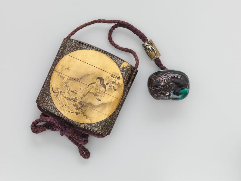 Small laquered box attached to a braided rope and netsuke fob.