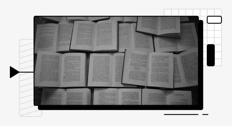 Stylized image of open text books lying on a table.