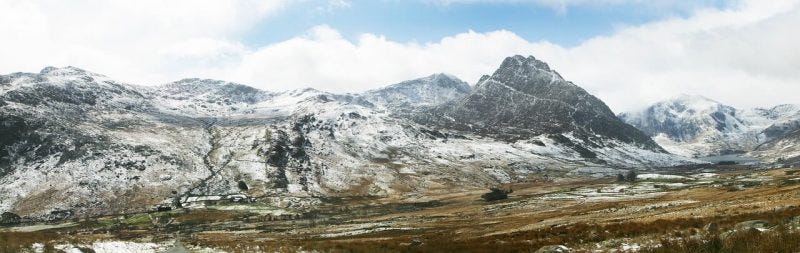 A scenic view of snow capped mountains in Snowdonia National Park