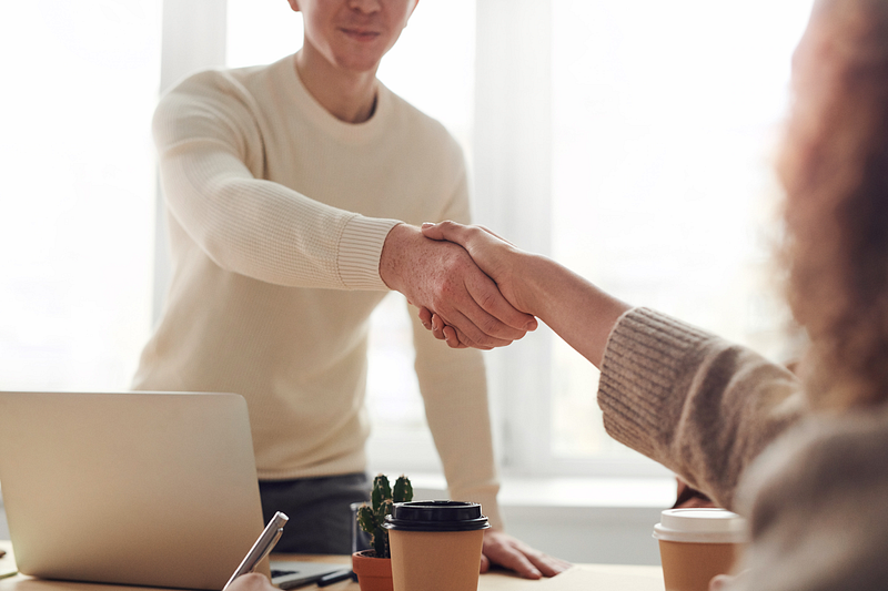 two outsourcing providers shaking hands