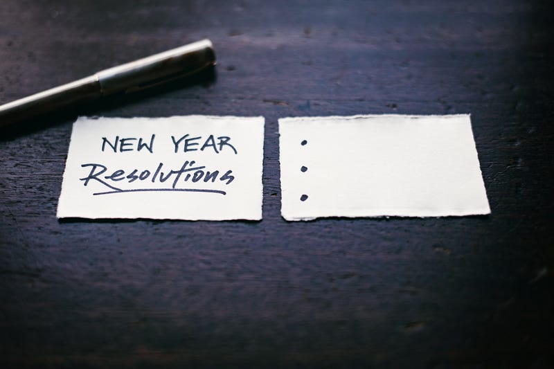 A sheet of paper with a pen next to it for you to create your New Year Resolutions.