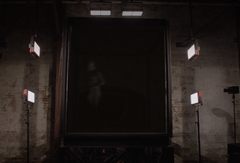 a female figure appears in the black box