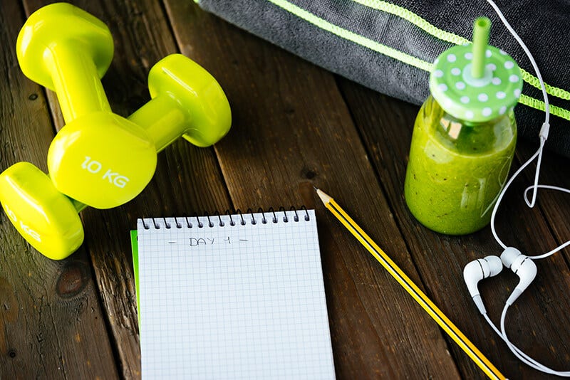 A group of exercise accessories including weights and earbuds