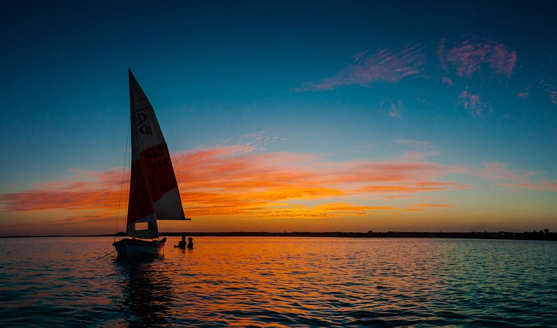 Yacht at sunset - Setting sail