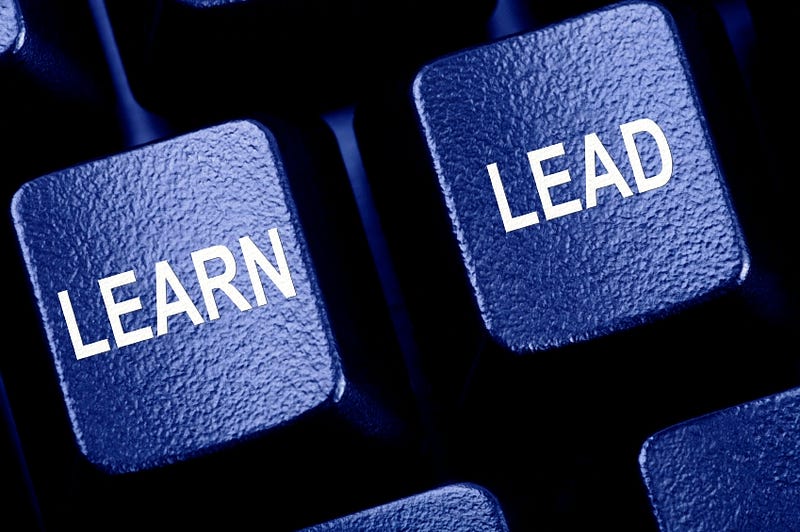 Computer keyboard keys labeled LEARN and LEAD