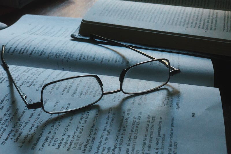 Eyeglasses on an open book as one researches