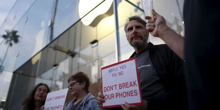 Personas protestando contra el FBI y a favor de Apple