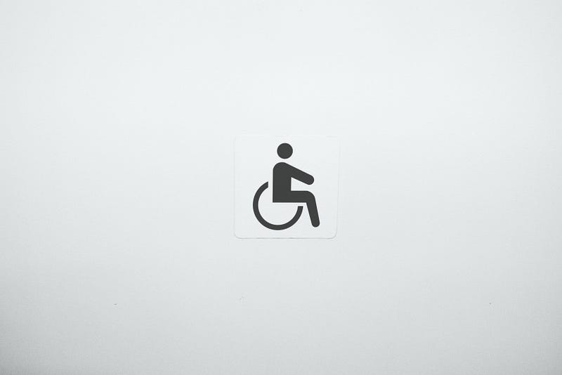 Well-known disability symbol (I.e. cartoon silhouette of human figure sitting in wheelchair)