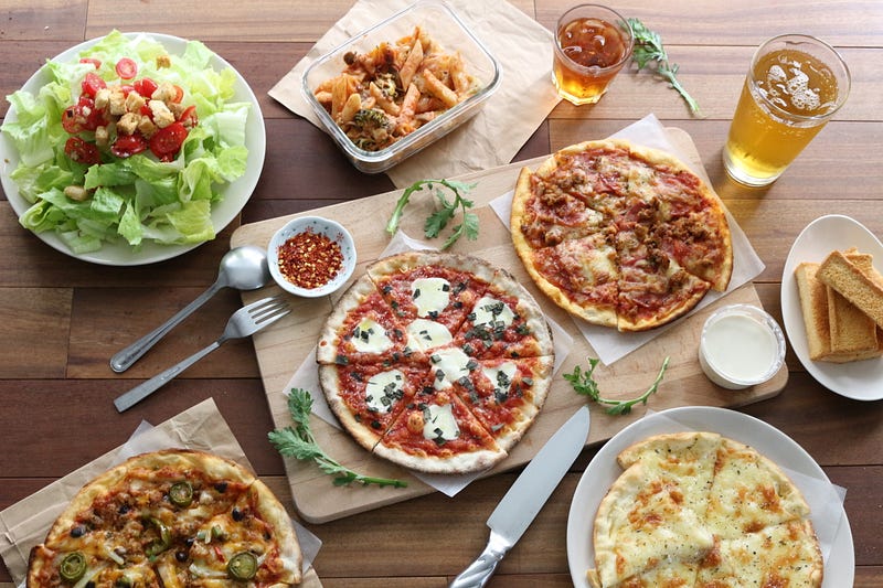 plates of pizza and salad on a table