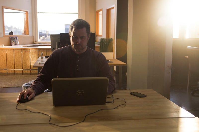 Rhys Faler works at his laptop in the Invent Startup Lab in Bellingham, WA