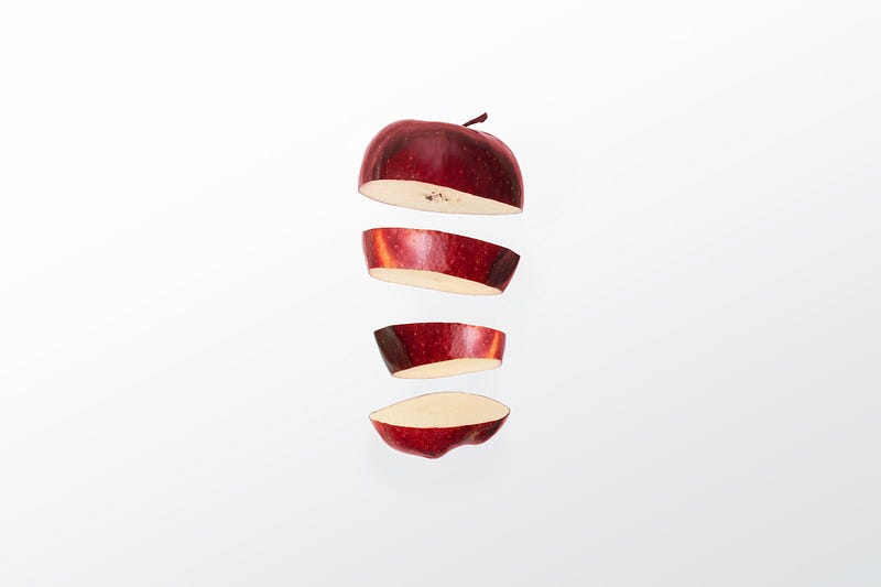 An apple sliced into four.
