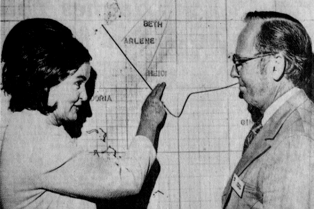 Roxcy Bolton (left) points at a map while talking to Robert Simpson (right).