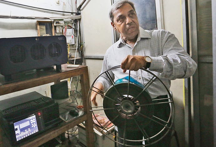 Vilas Tapre showing a century-old film reel of a movie shown at Vasant Talkies 