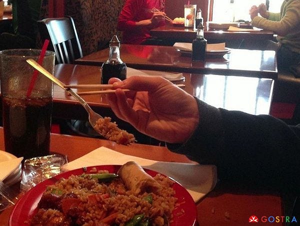 Chopsticks holding fork
