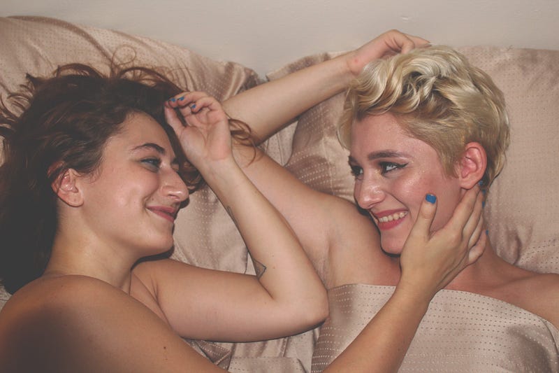 Two women laying in bed