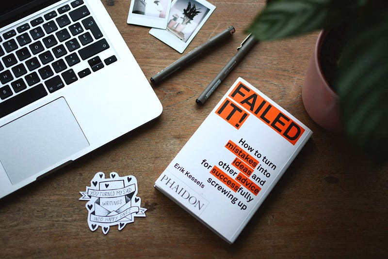 Desktop with a book entitled “Failed It” how to turn mistakes into success.