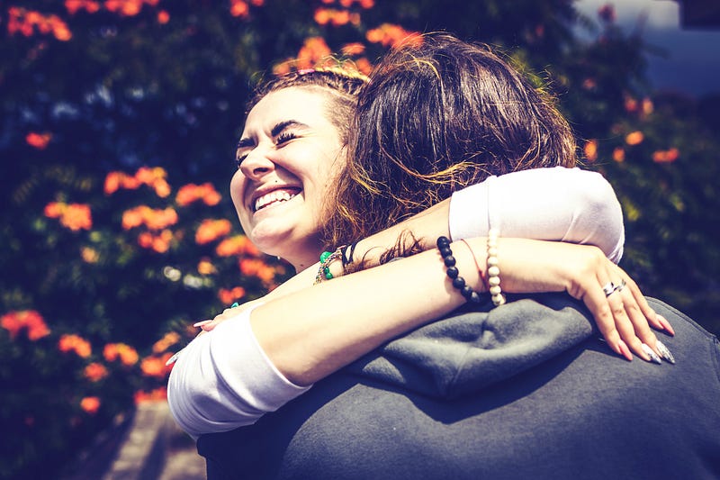 Two women hugging and smiling