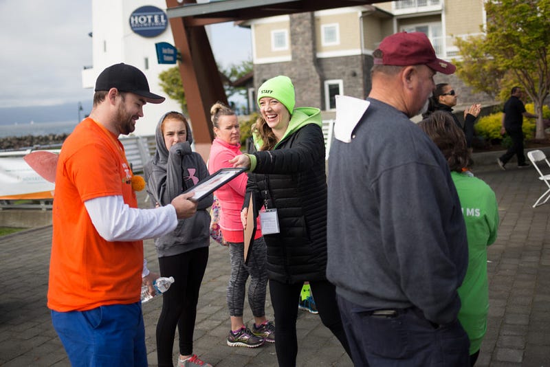 Event manager, Molly Johnston hands an award to one of the Walk MS: Bellingham participants during the event on Saturday, April 9th. The top teams raised between $2,000 and $8,000 to combat MS.