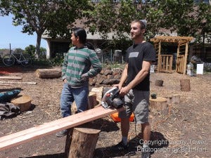 Student volunteers Benjamin Heim and Esteban Quizhpe prepare for construction of garden bed.