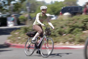 A student cyclists onto the Laney College campus.