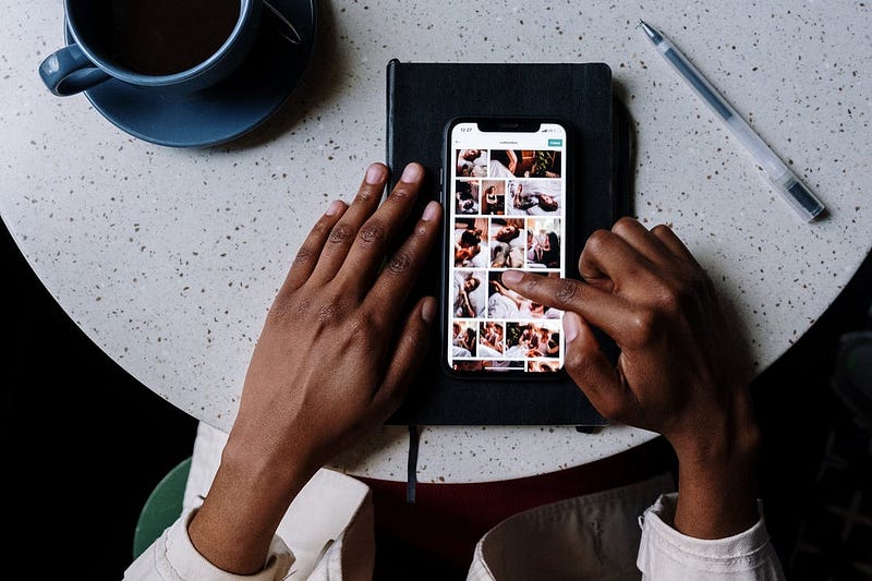 Aerial view of someone scrolling through images on their phone.