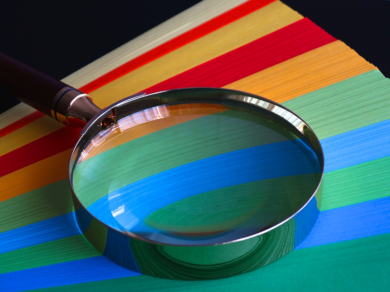 colored papers under a magnifying glass