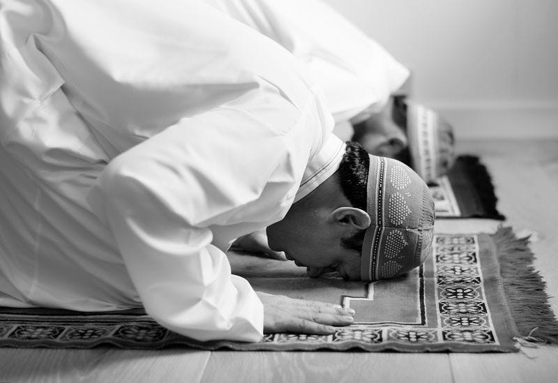 Muslims prostrating in prayer